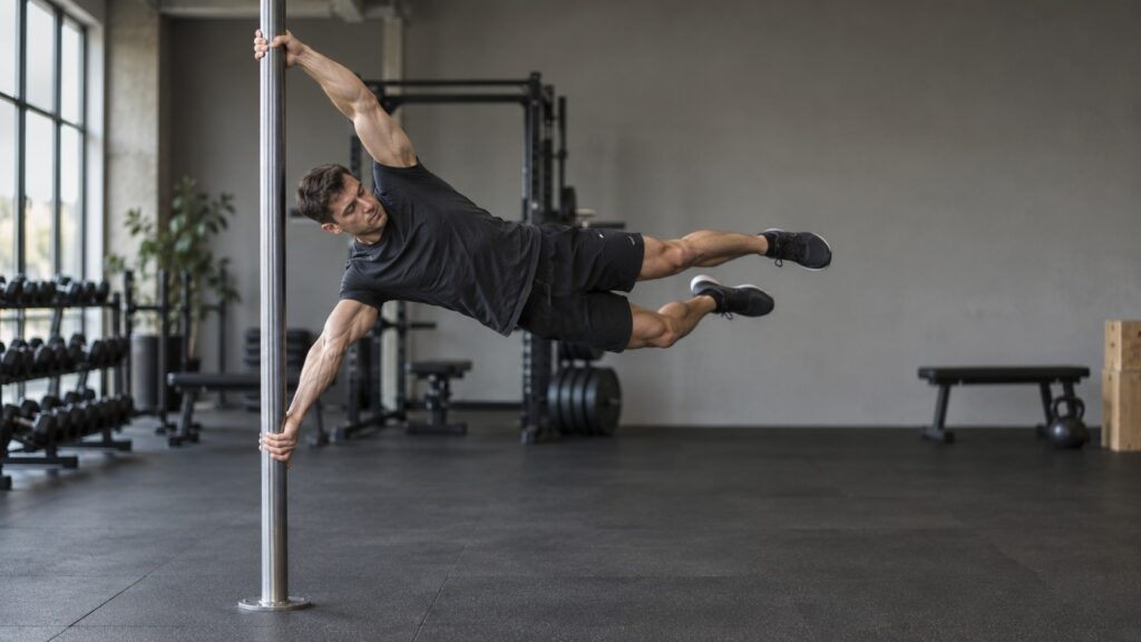 Human-Flag-practice-on-a-vertical-pole-in-a-gym