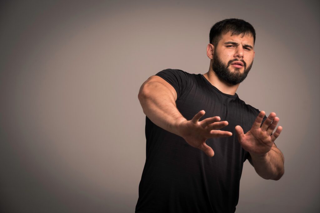 Man-stopping-motion-confused-expression-black-shirt