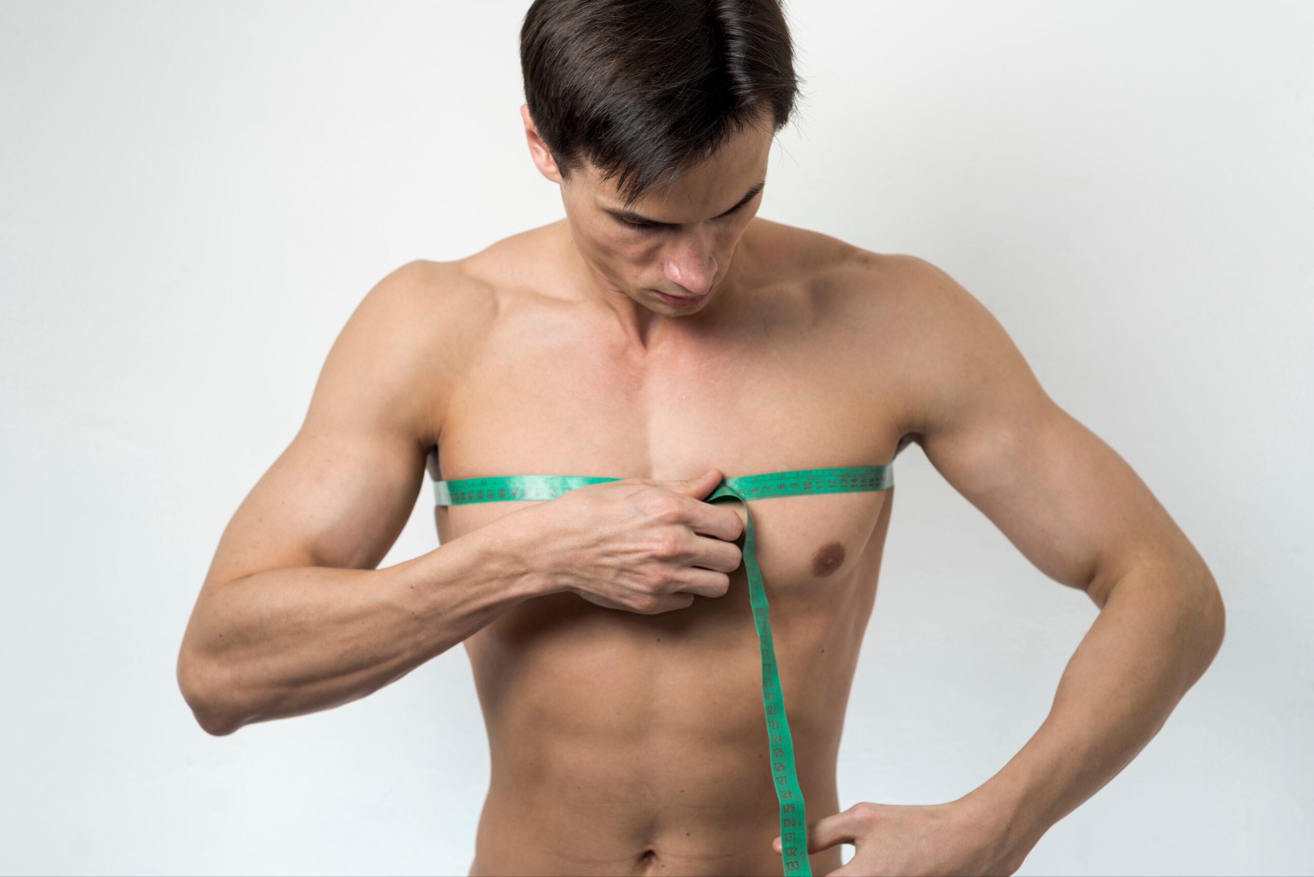 Ectomorph-man-measuring-chest-with-tape