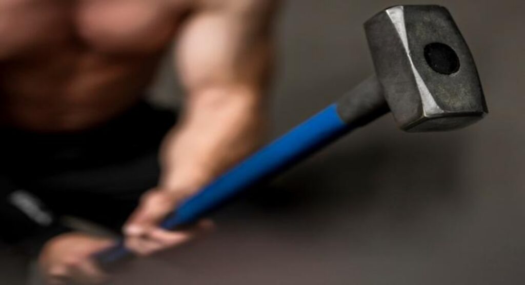 Man-holding-a-sledgehammer-for-grip-strength-training