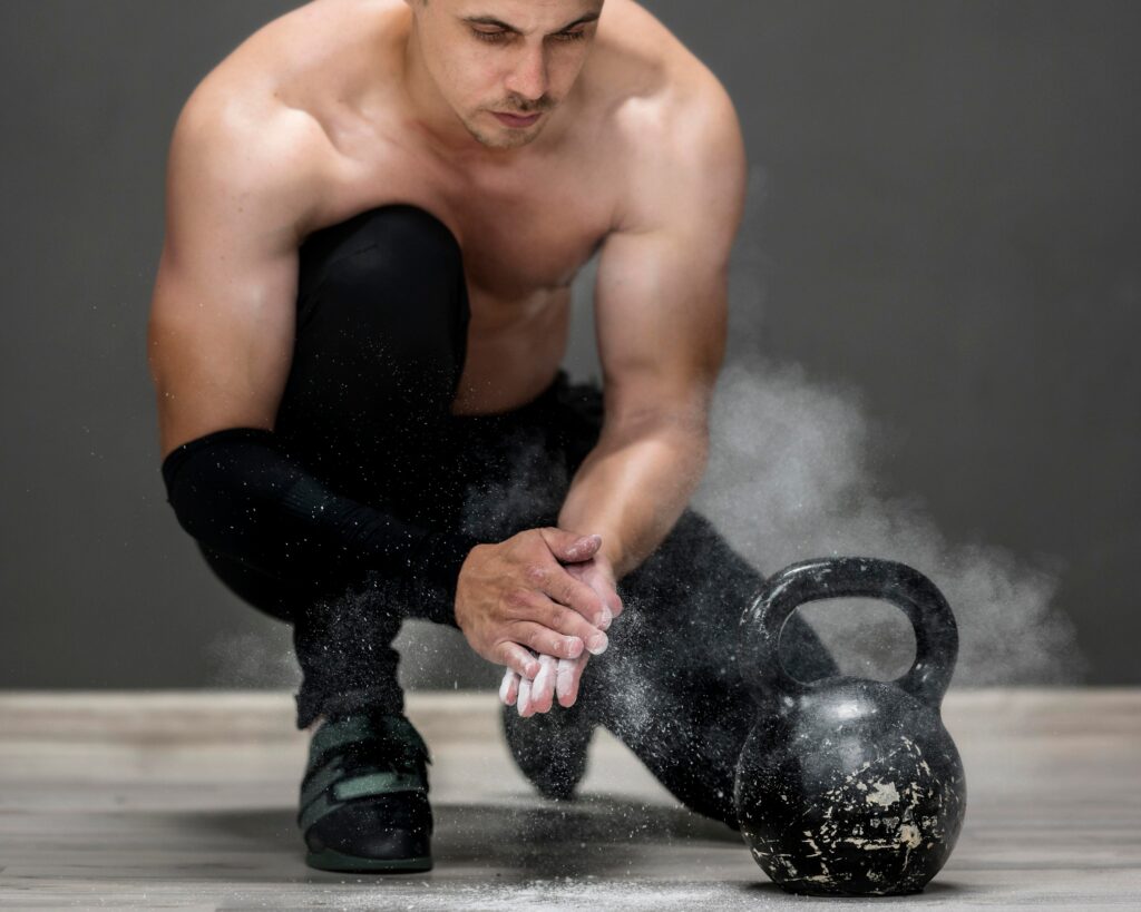 Man-kneeling-on-gym-floor-with-a-kettlebell