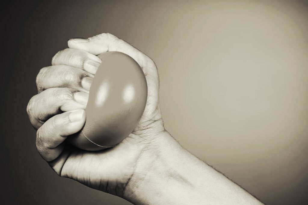 Hand-squeezing-stress-ball-to-improve-grip-strength