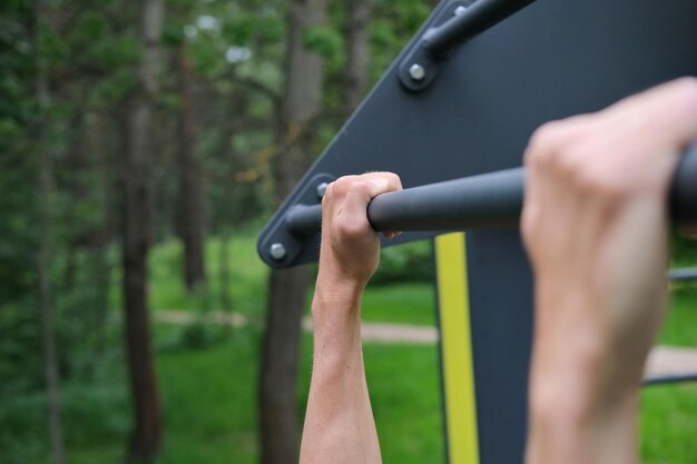 Close-up-hands-gripping-pull-up-bar