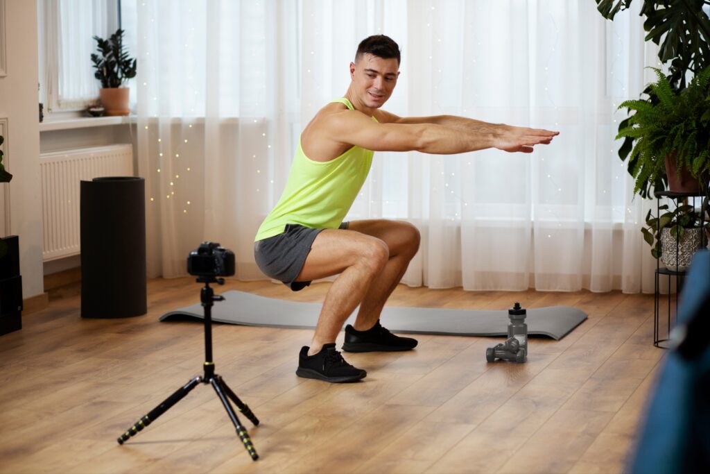 Man-filming-himself-for-proper-squat-technique