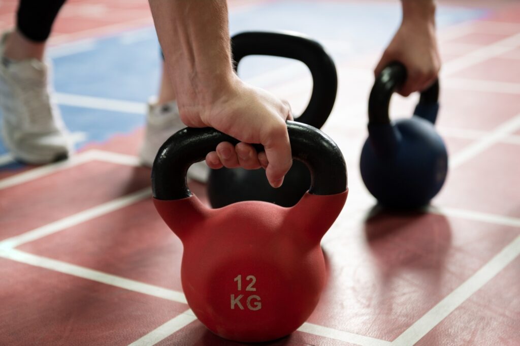 12-kg-red-kettlebell-grip-gym-floor-strength-training