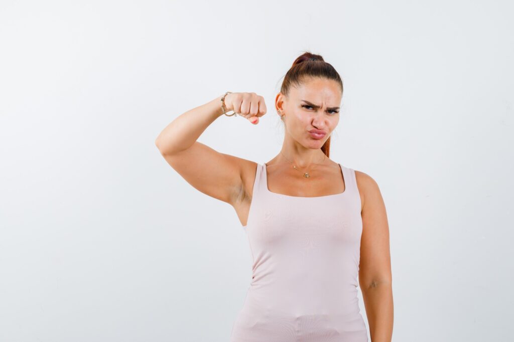 Woman-flexing-arm-fitness