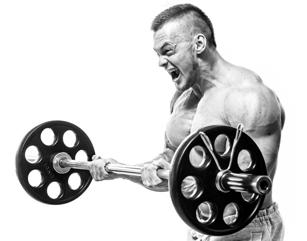 Muscular-man-lifting-heavy-barbell-with-intense-expression