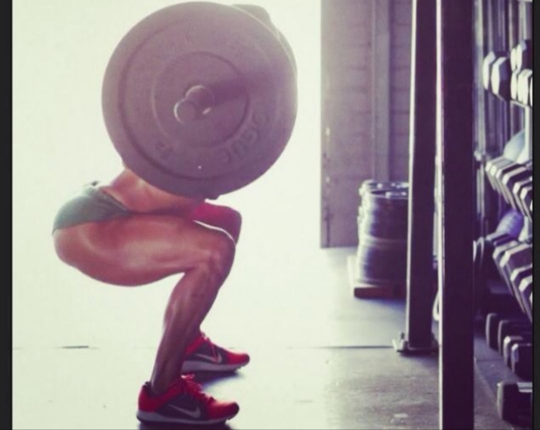A-man-performs-a-squat-by-lowering-himself-until-his-knees-form-a-90-degree-angle
