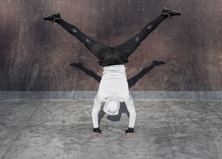 Back-view-athletic-man-doing-handstand