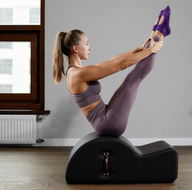 Modern-pilates-reformer-machine-with-back-corrector-in-gym-setting