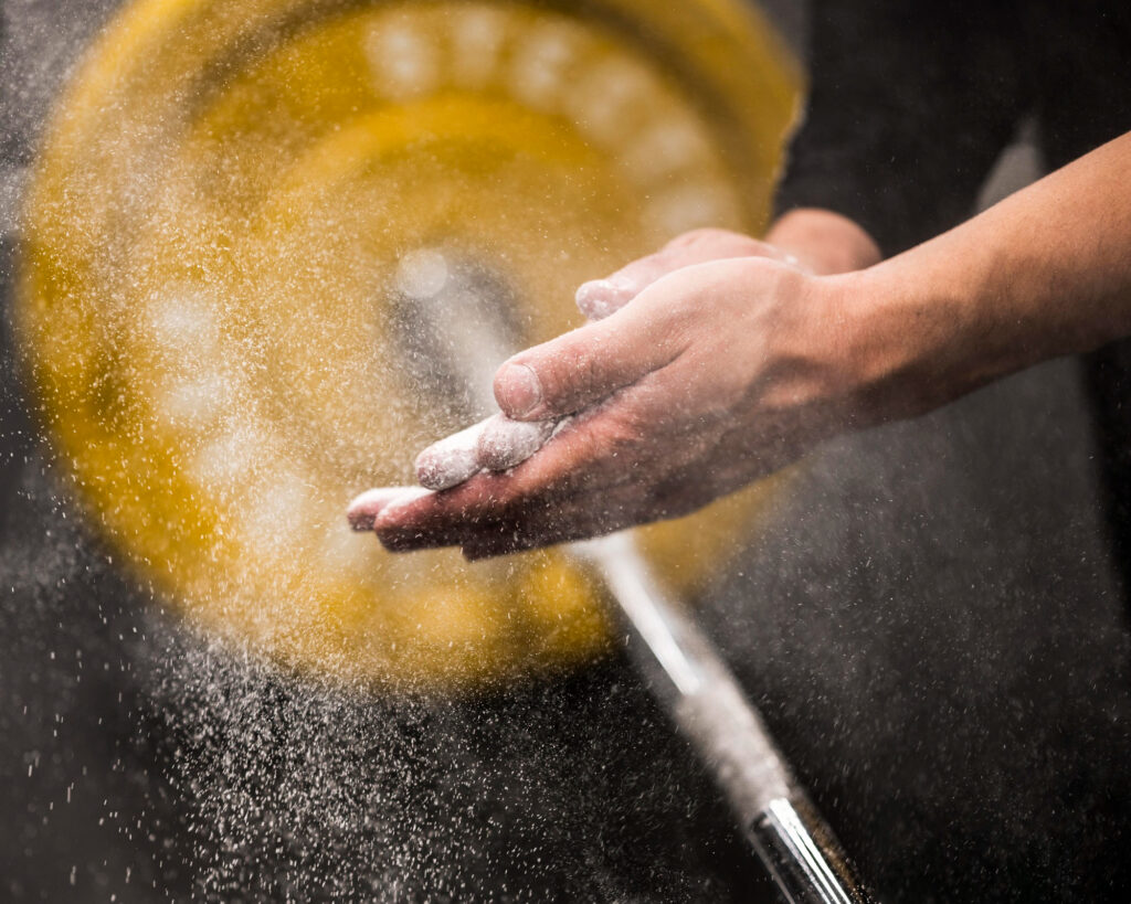 athlete-clapping-hands-with-chalk-before-lift