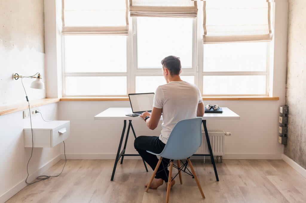 Man-working-from-home-sitting-at-a-desk